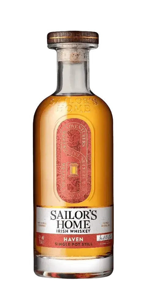 Irischer Whiskey Sailor's Home HAVEN in einer klaren Flasche mit goldener Flüssigkeit und rotem Etikett.